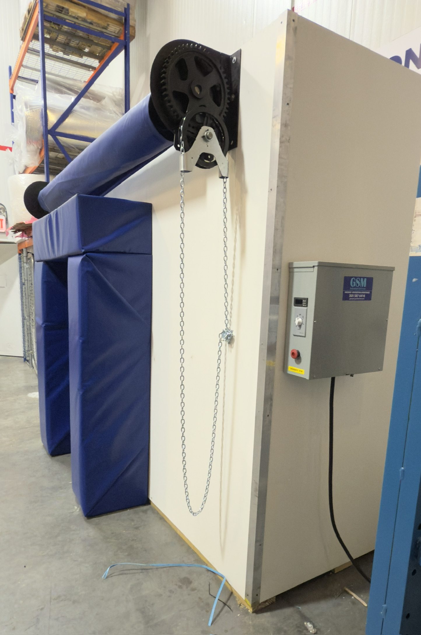 Chain roll-up mechanism and GSM control box on precooler side panel